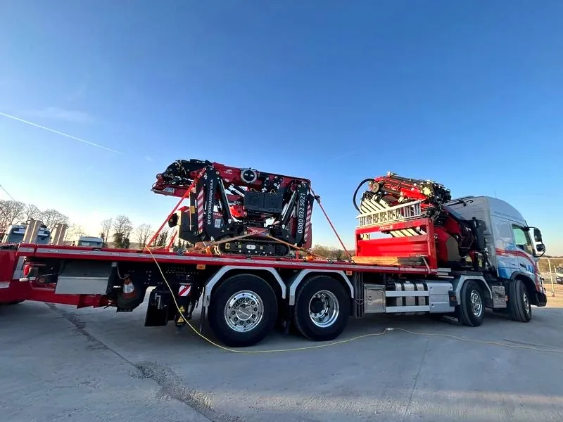 WB Services Hiab truck delivering a tracked spider crane strapped to its flatbed